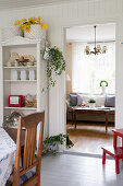 View from white kitchen-dining room into classic living room