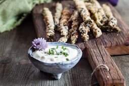 Fried breaded asparagus with almond flour and sesame seeds, and a herb dip