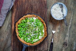 A flour-free spring tart with steamed asparagus, peas, goat's cheese, cress and Parmesan