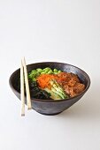 Poke bowl with salmon, edamame, seaweed and sesame oil