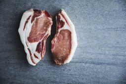 Two raw free-range organic pork chops (seen from above)