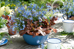 Table decoration with forget-me-nots and salad