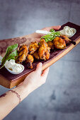 Grilled chicken wings on a wooden board