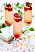 Prosecco jelly with raspberries in tall glasses