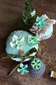 Arrangement of ornaments and green origami flowers