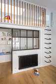 Wall-mounted ladder rungs leading to mezzanine in child's bedroom