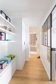 Shelves and fitted cupboards in hallway with wooden floor