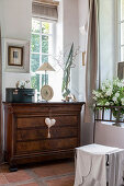 Antique chest of drawers below lattice window