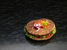 A hamburger on a halved burger bun