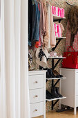 Feminine accessories in walk-in wardrobe in bedroom