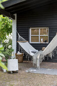 Hammock on veranda outside wooden house