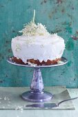 A cake with vanilla cream frosting and elderflowers