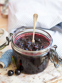 A jar of cherry chutney with a spoon