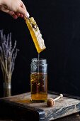 A jar of honey with honeycomb