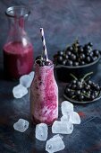 A blackcurrant smoothie with ice cubes