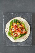 A tortilla wrap with shrimps and mango