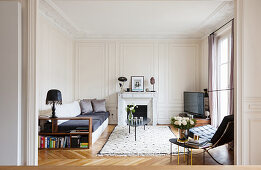 Panelled walls and designer furniture in living room