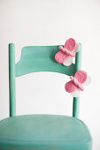 Hand-made, pink, felt butterflies on green chair