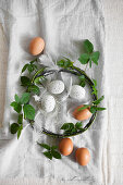 Brown eggs, white speckled eggs and wreath of blackberry tendrils