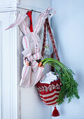 Carrots in hand-made, bunny-shaped cloth bag and basket made from bobble hat