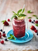 A mixed berry smoothie with mint and lemon