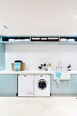 Washroom with light blue shelves and cupboard fronts