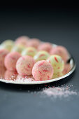 Colourful truffle pralines with sugar on a silver tray