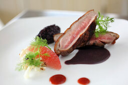 Roasted duck breast with black rice, grapefruit and fennel
