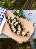 Mozzarella skewers with basil and blueberries