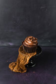 A chocolate cupcake with chocolate cream icing