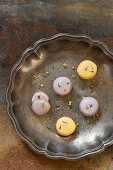 Yellow and purple macaroons with cornflower petals