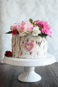 Strawberry and pistachio cake decorated to look like a silver birch