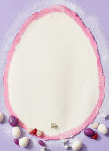 A white, egg-shaped background with sugared eggs