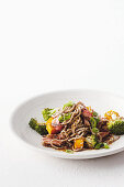 Beef with honey and soy marinade, vegetables and noodles