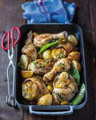 Lemon chicken with green olives in an oven tray