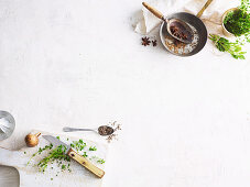 View of white area with spices, herbs and utensils