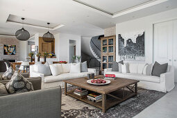 Sofas, armchair and coffee table in open-plan interior