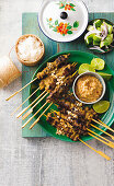Malaysian beef satay skewers served with a dip and rice (Asia)