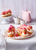 Eclairs with buttercream and strawberries