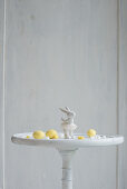 Easter bunny ornament and marzipan eggs on white table