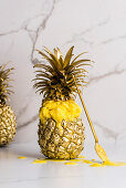 Pineapple ice cream served in a gilded pineapple