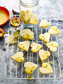 Gluten-free passion fruit biscuits with passion fruit icing on cooling rack