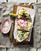 Three great Smørrebrød toppings: Herring and potato, Egg, gherkin and roe, Ham and cheese