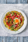 A courgette pizza with a fried egg