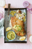 Beer-battered fish with a yellow cucumber and onion sauce