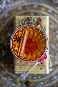 Buchu honeybush tea with gin and pomegranate seeds