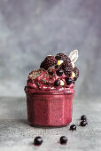 A blueberry and blackberry ice cream smoothie with chia seeds