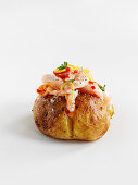 A baked potato with prawns, salmon and chilies