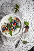 Smoothie bowl with yougurt, blueberries, seed and mint leaves