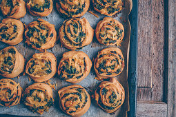 Vegan spinach buns with cheese on baking paper